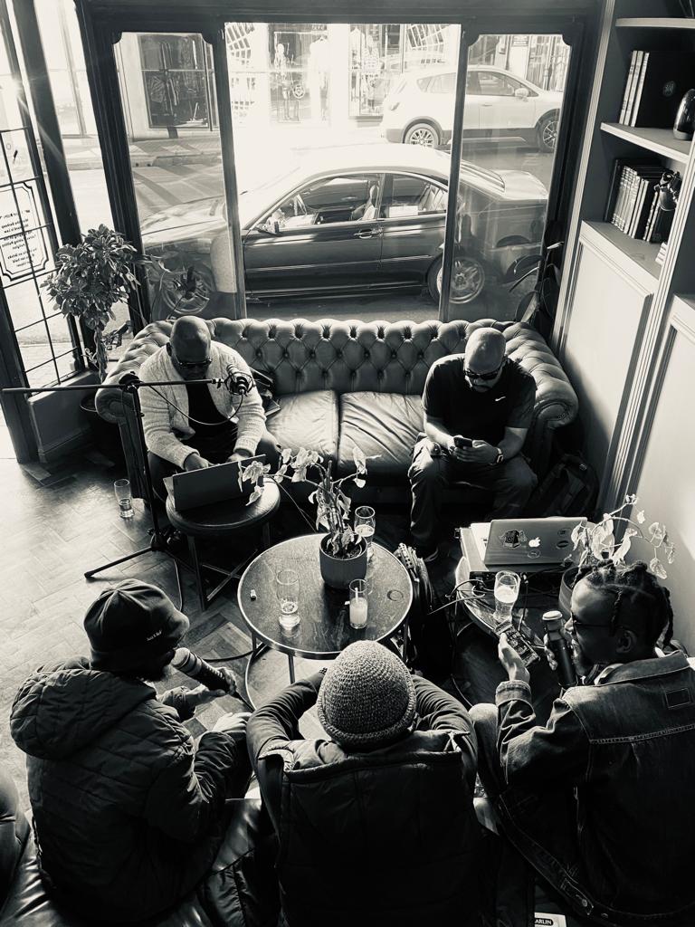 Deepsoulja radio guests gathered around microphones in a lounge.