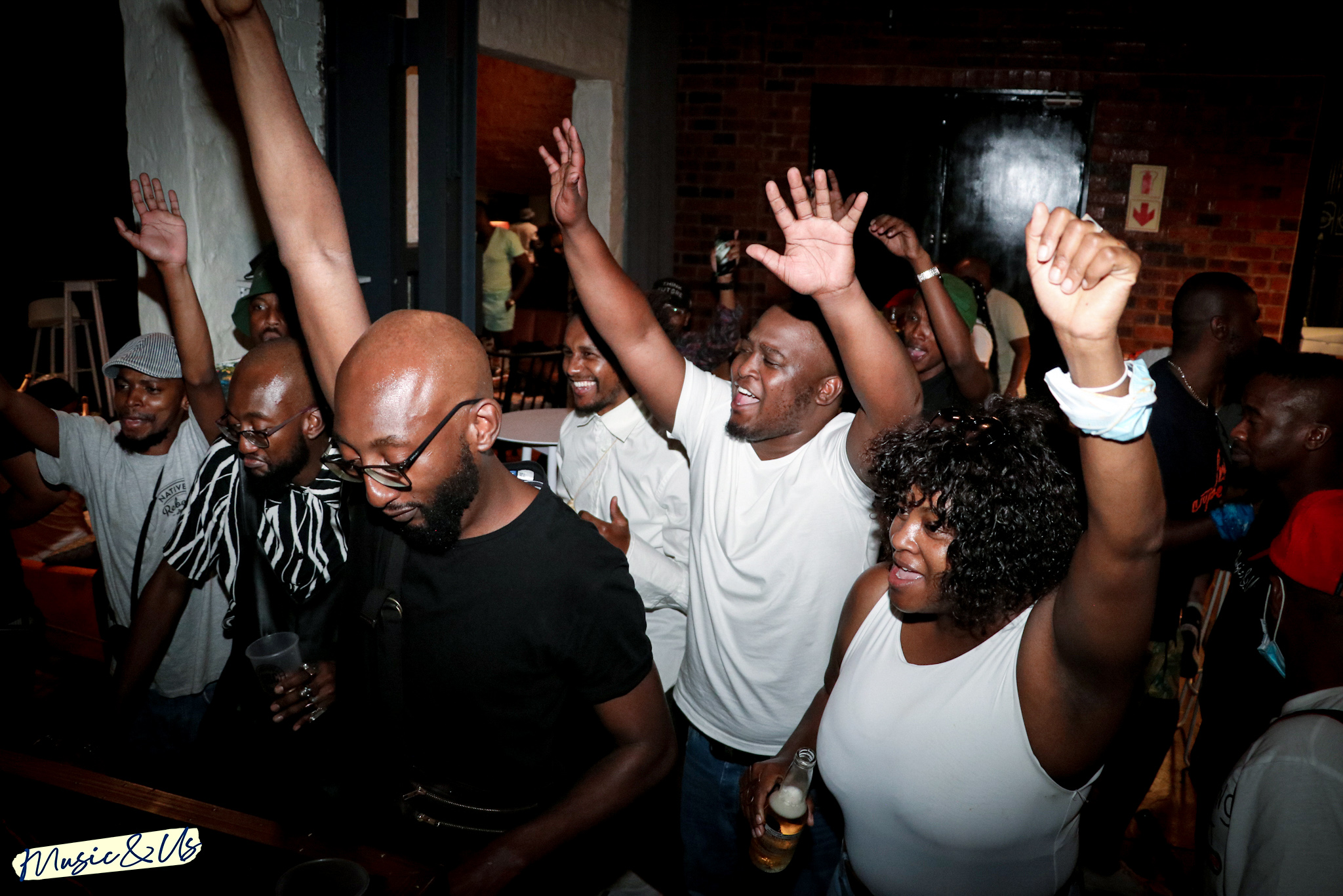 Deepsoulja guests raising their hands on a crowded dance floor.